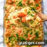 An incredible creamy chicken and rice casserole recipe made with frozen peas and carrots and cream of chicken soup.