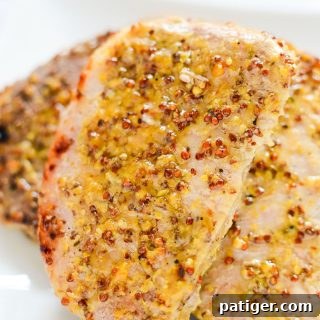Juicy oven roasted pork chops with a delicious honey and grainy mustard sauce.