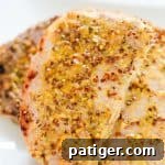 Juicy oven roasted pork chops with a delicious honey and grainy mustard sauce.