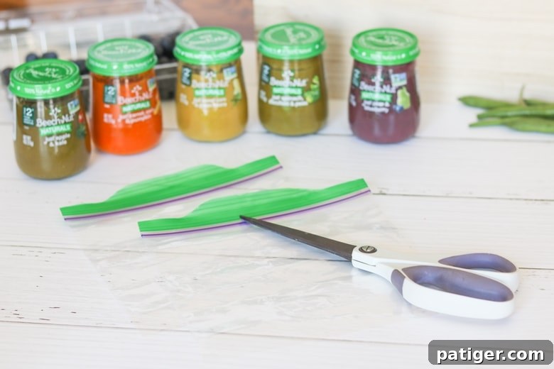 Supplies for making frozen fruit dots: sandwich bag, scissors, wax paper, baking sheet