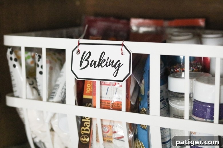 White pantry basket labeled "baking" and filled with baking supplies