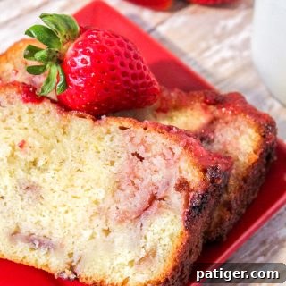 Easy homemade strawberry yogurt pound cake with a strawberry glaze and fresh strawberries.