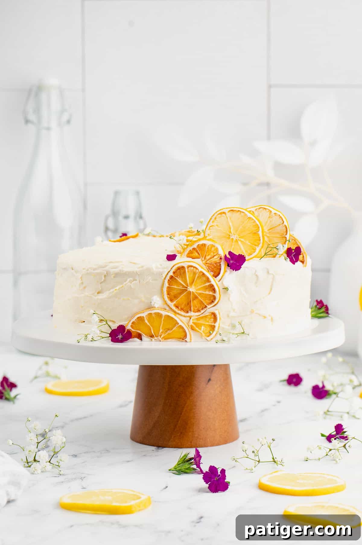 Lemon cake decorated with dehydrated lemon slices and edible flowers.