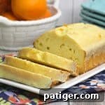 A delicious orange quick bread topped with a sweet orange glaze, for sharing on social media.