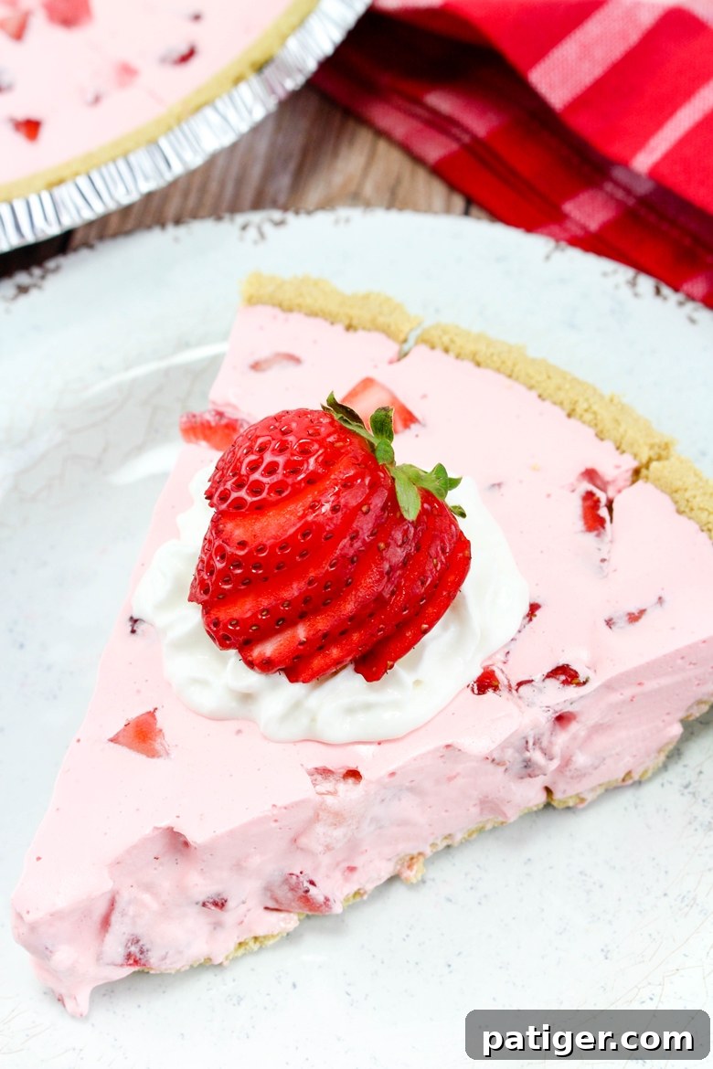 Pink jello pie with strawberries and Cool Whip.