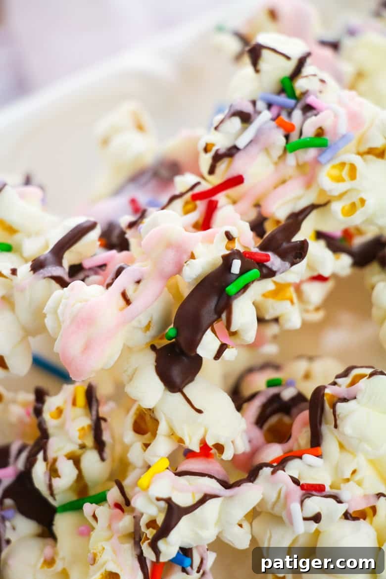 Sundae Popcorn with colorful drizzles and an assortment of sprinkles