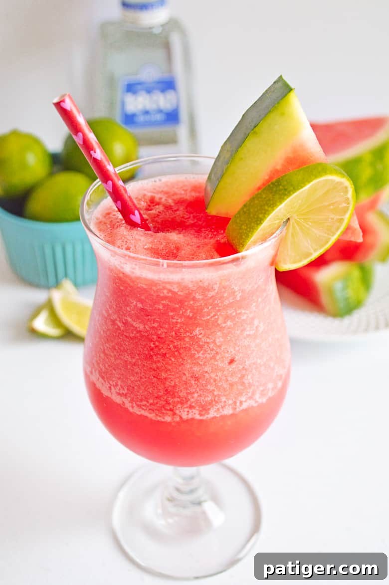 Frozen Watermelon Margarita garnished with watermelon slice and lime slice