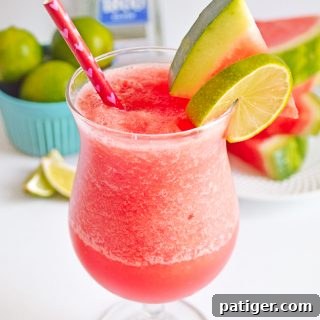 Frozen Watermelon Margarita garnished with watermelon slice and lime slice