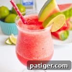 Frozen Watermelon Margarita garnished with watermelon slice and lime slice
