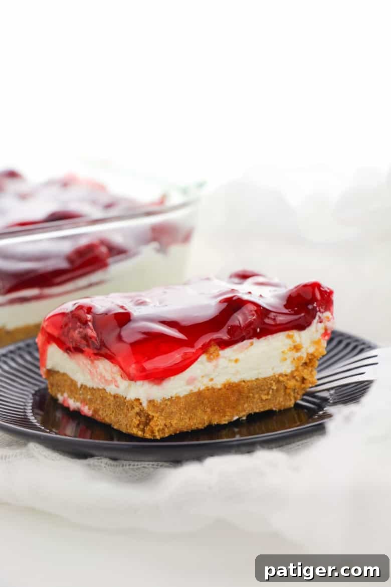 A full No Bake Cherry Cheesecake in an 8x8 inch dish, ready to be served.
