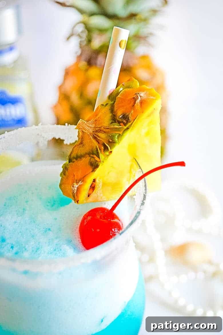 Ocean Siren Margarita Freeze 3 Margarita glass with a sugar-salt rim and garnished with a lime slice and cherry