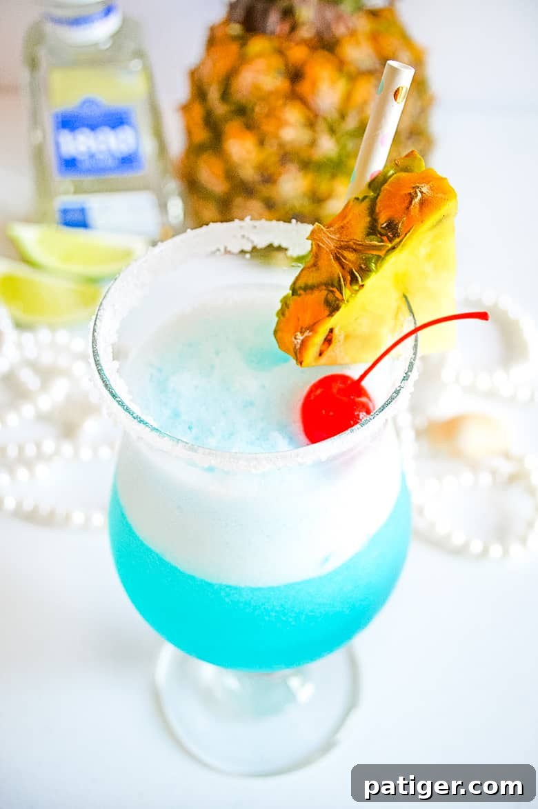 Ocean Siren Margarita Freeze 4 Close-up of a Frozen Blue Margarita with a lime wedge garnish