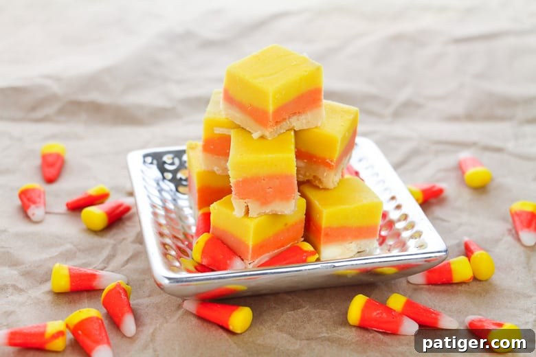 Festive Candy Corn Fudge 4 Candy Corn Fudge on silver platter, with candy corn sprinkled around the table.