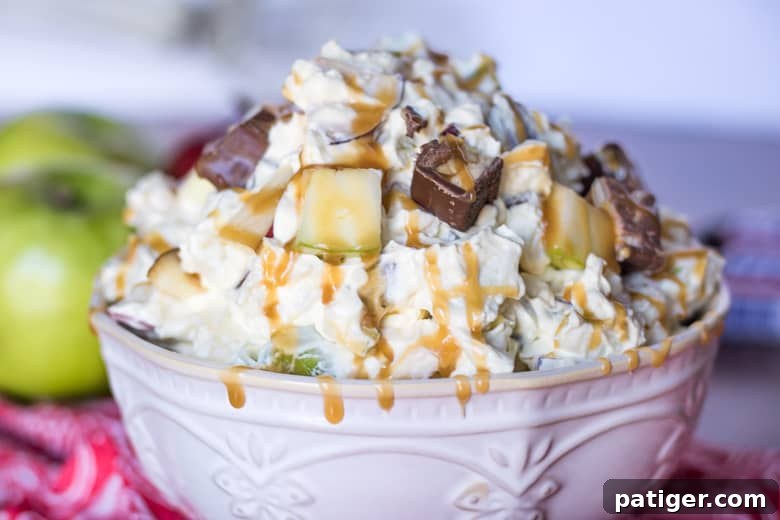 Ultimate Snickers Caramel Apple Salad 6 A bowl of Caramel Apple Snickers Salad, perfectly portioned and ready to serve, highlighting its appealing textures and colors.