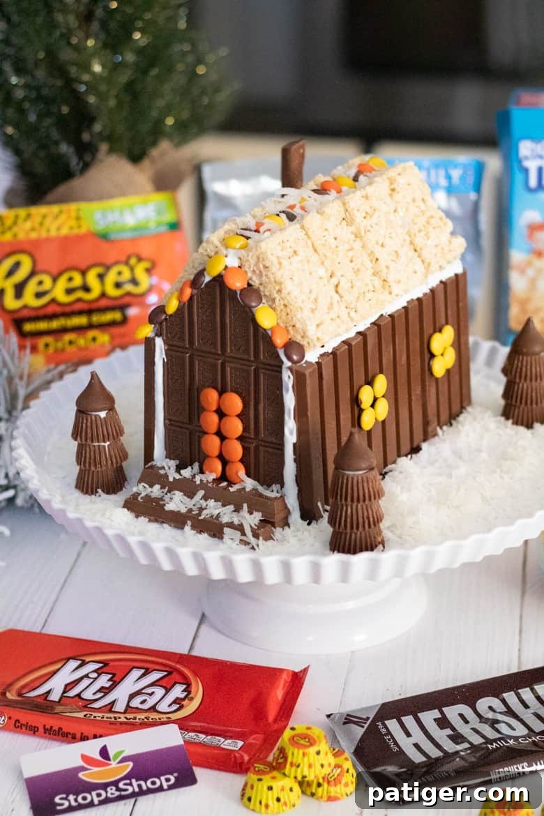 Festive Sweet Retreat 2 Christmas candy house with KitKat Bar, Hershey's Bar, Reese's Pieces, Reese's Peanut Butter Cups, and Rice Krispies Treats.