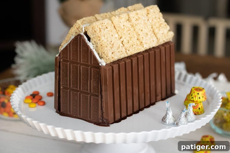 Festive Sweet Retreat 5 How to Make a Candy Cabin with kit kat and Hershey bar walls and a Rice Krispies Treat roof.