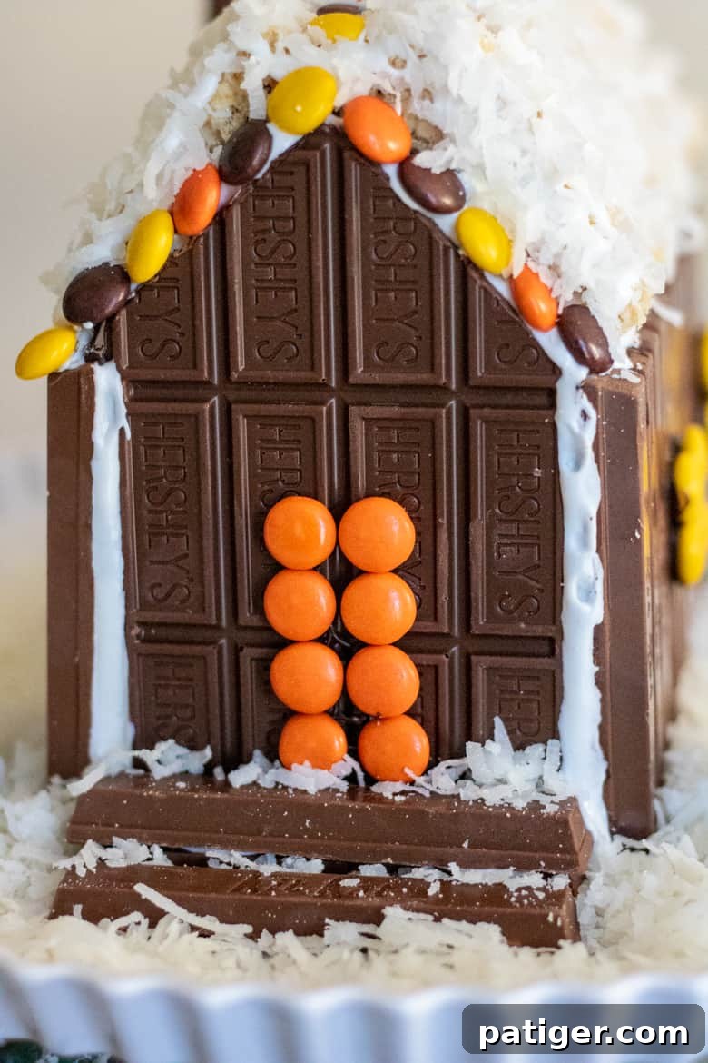 Festive Sweet Retreat 10 Front of Candy Cabin with orange Reese's Pieces front door and kit kat steps.