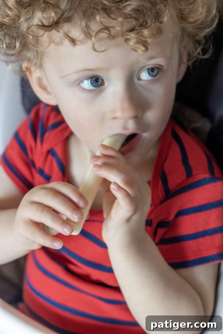 Child enjoying a PAW Patrol String Cheese snack.
