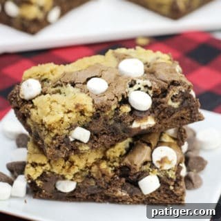 Hot Chocolate Brookies with melted chocolate and marshmallows on a serving plate