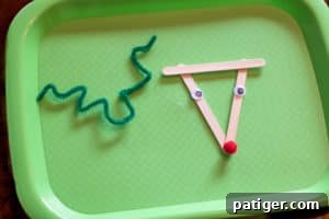 Green pipe cleaner bent into a zig-zag pattern for antlers and glued to the back of the reindeer ornament