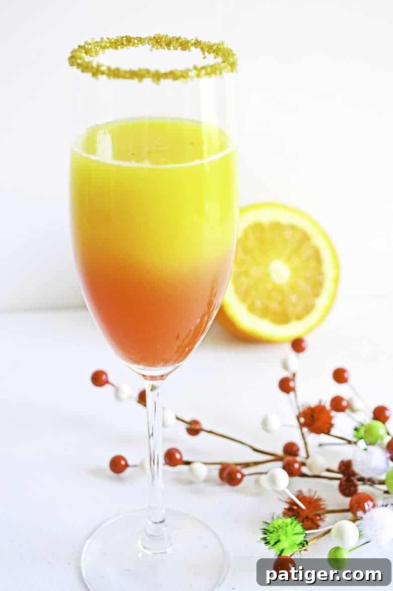 Christmas Mimosa recipe in a beautifully garnished cocktail glass, ready for holiday celebrations