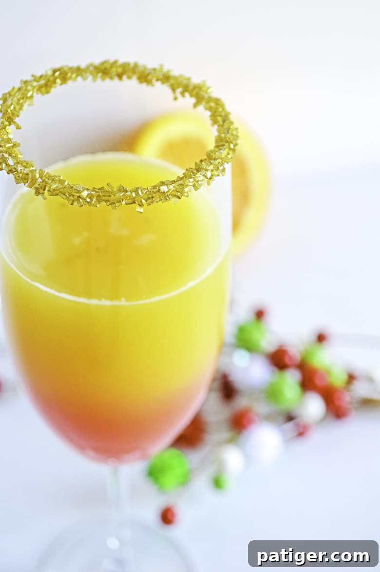 A festive Christmas Mimosa in a champagne glass, perfectly garnished and ready to be enjoyed during the holidays