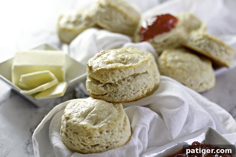 Fluffy Buttermilk Biscuits from Scratch 15 A close-up shot of freshly baked buttermilk biscuits arranged on a wooden board, with a soft, inviting focus on their texture and golden color.