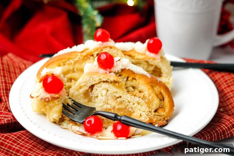 Slices of Swedish Tea Ring elegantly arranged on a plate with a fork and a coffee mug in the background, inviting a moment of indulgence.