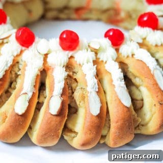 Swedish Tea Ring Topped with Frosting and Cherries