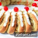 Swedish Tea Ring Topped with Frosting and Cherries