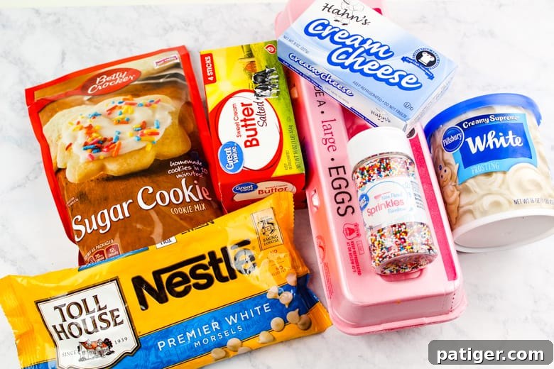 Ingredients laid out for making sugar cookie truffles: sugar cookie mix, softened cream cheese, vanilla frosting, and white chocolate chips