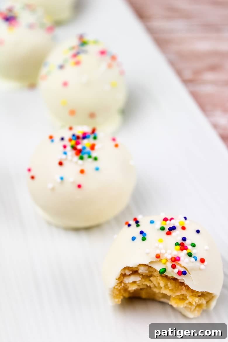 A row of beautifully decorated sugar cookie truffles on a serving plate, ready for a holiday gathering