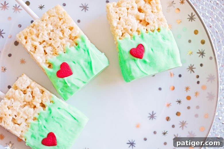 Grinch's Green Krispie Delights 3 An array of festive Grinch snacks including the green Rice Krispie treats, perfect for holiday movie nights.