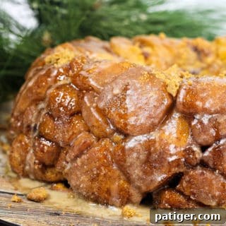 Gingerbread Monkey Bread on a platter, showcasing its sticky, glazed surface and festive appearance.
