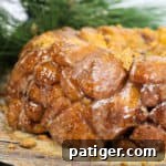 Gingerbread Monkey Bread on a platter, ready to be served, highlighting its sticky, sweet glaze.