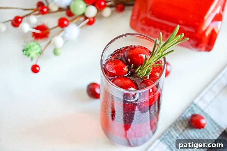 Ruby Sparkler 3 Overhead view of two cranberry mimosas with garnishes