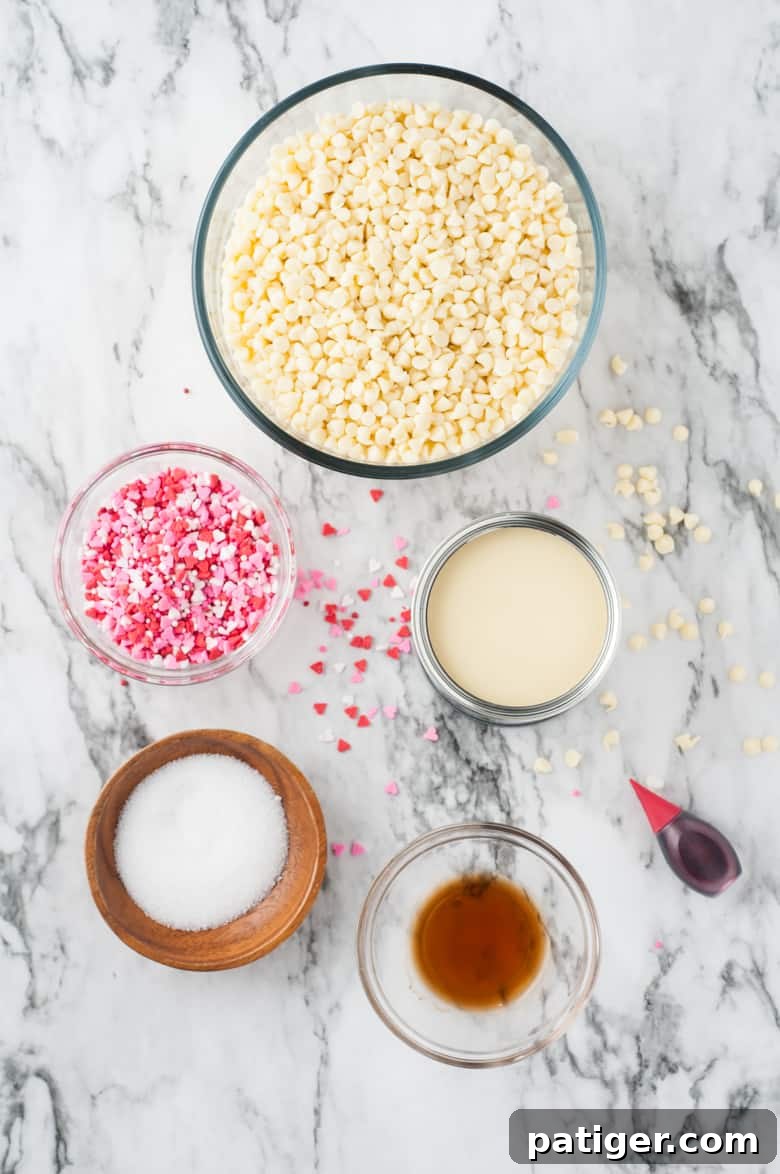 Velvet Valentine Fudge 4 Valentine's Day Fudge Ingredients: white chocolate chips, heart sprinkles, can of sweetened condensed milk, vanilla extract, salt, and red food coloring.