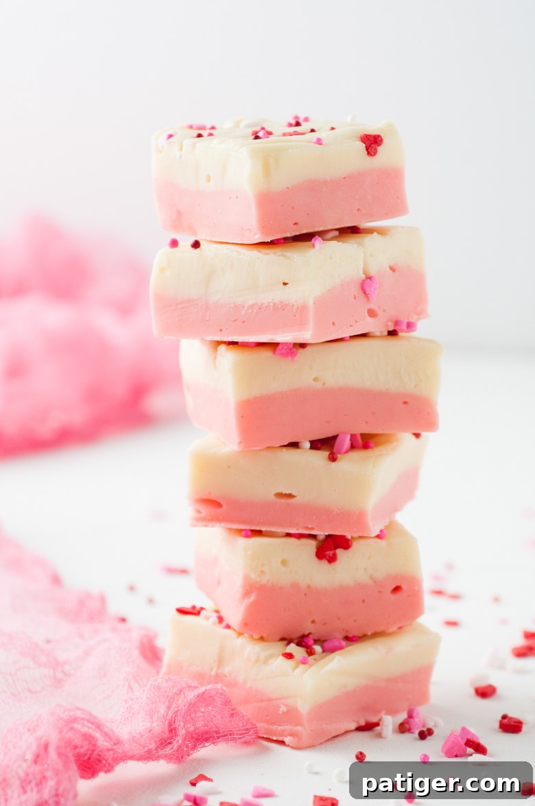 Velvet Valentine Fudge 9 Six pieces of pink and white fudge staked on top of each other to make a tower.