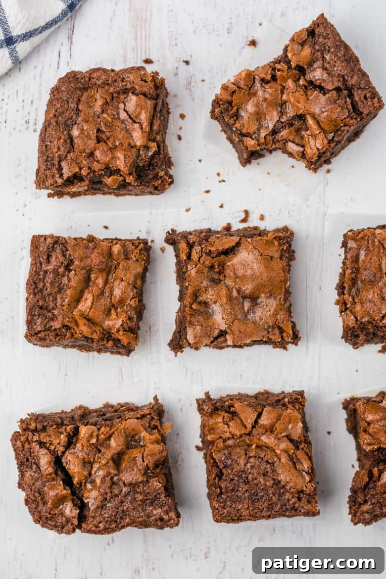 Easy Brownie Recipe - A stack of homemade fudgy brownies on a cooling rack.
