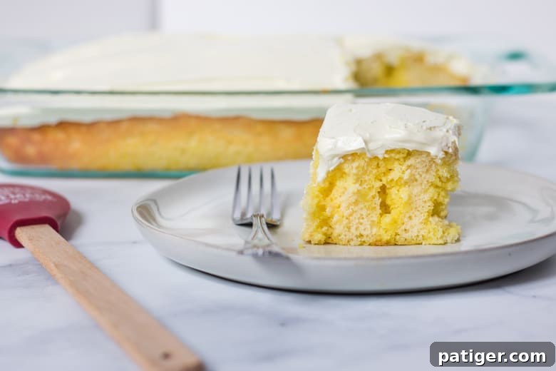 Fully prepared Lemon Poke Cake, frosted and ready to eat