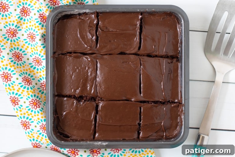 Crazy Chocolate Cake baked in a square pan and topped with chocolate frosting.