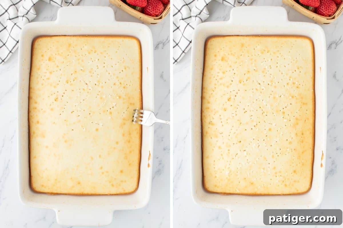 Strawberry Infusion Poke Cake 4 A rectangular white cake with a person using a large fork to poke numerous holes all over its top surface.