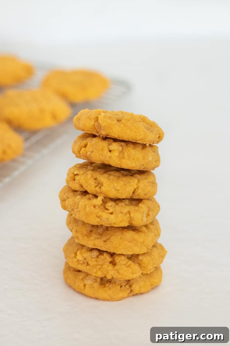 Golden Rice Krispies Cheddar Cheese Cookies stacked high on a plate