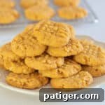 Cheese Cookies on a white plate with cookie on cooling rack in background