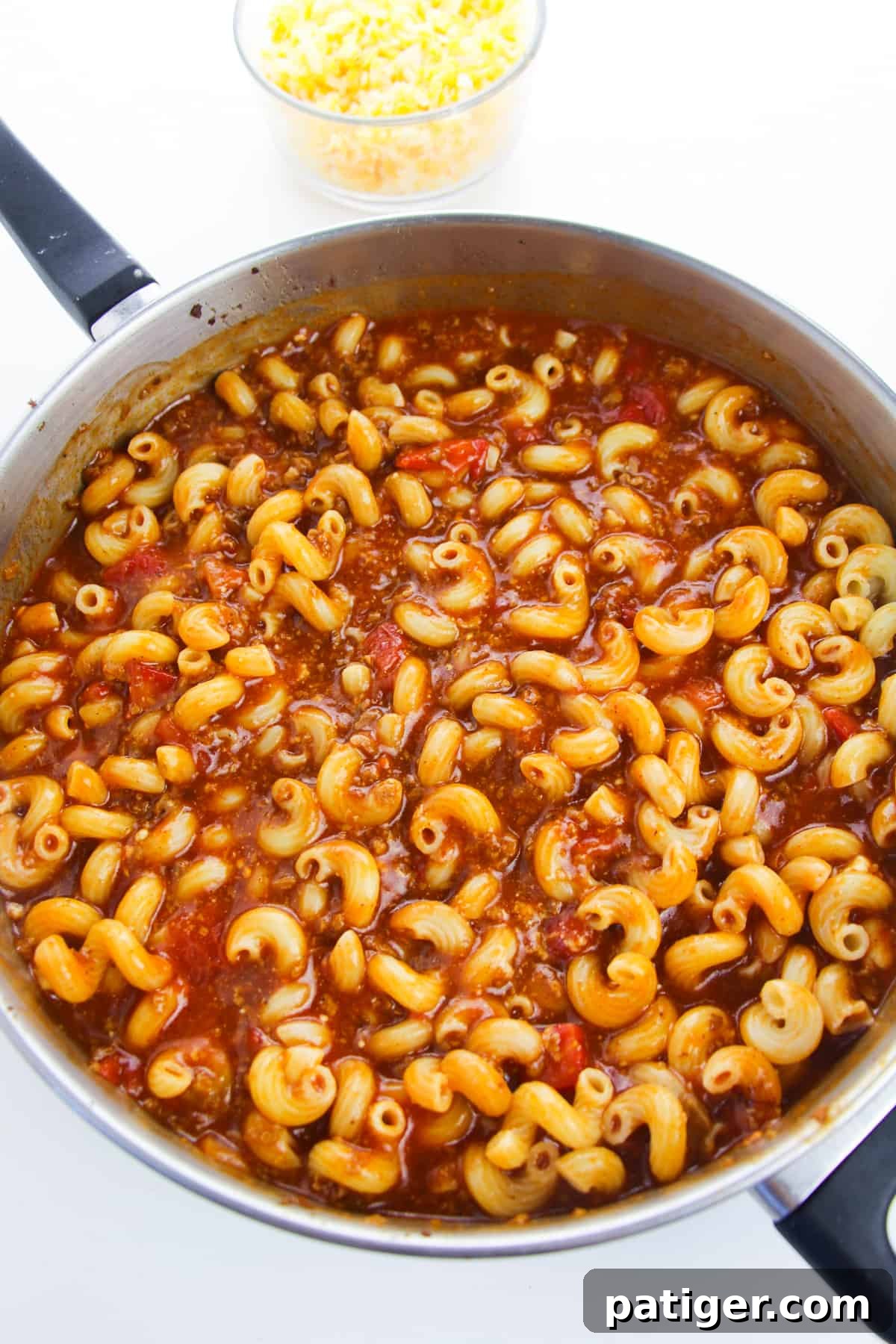 large skillet with pasta in an enchilada and tomato sauce