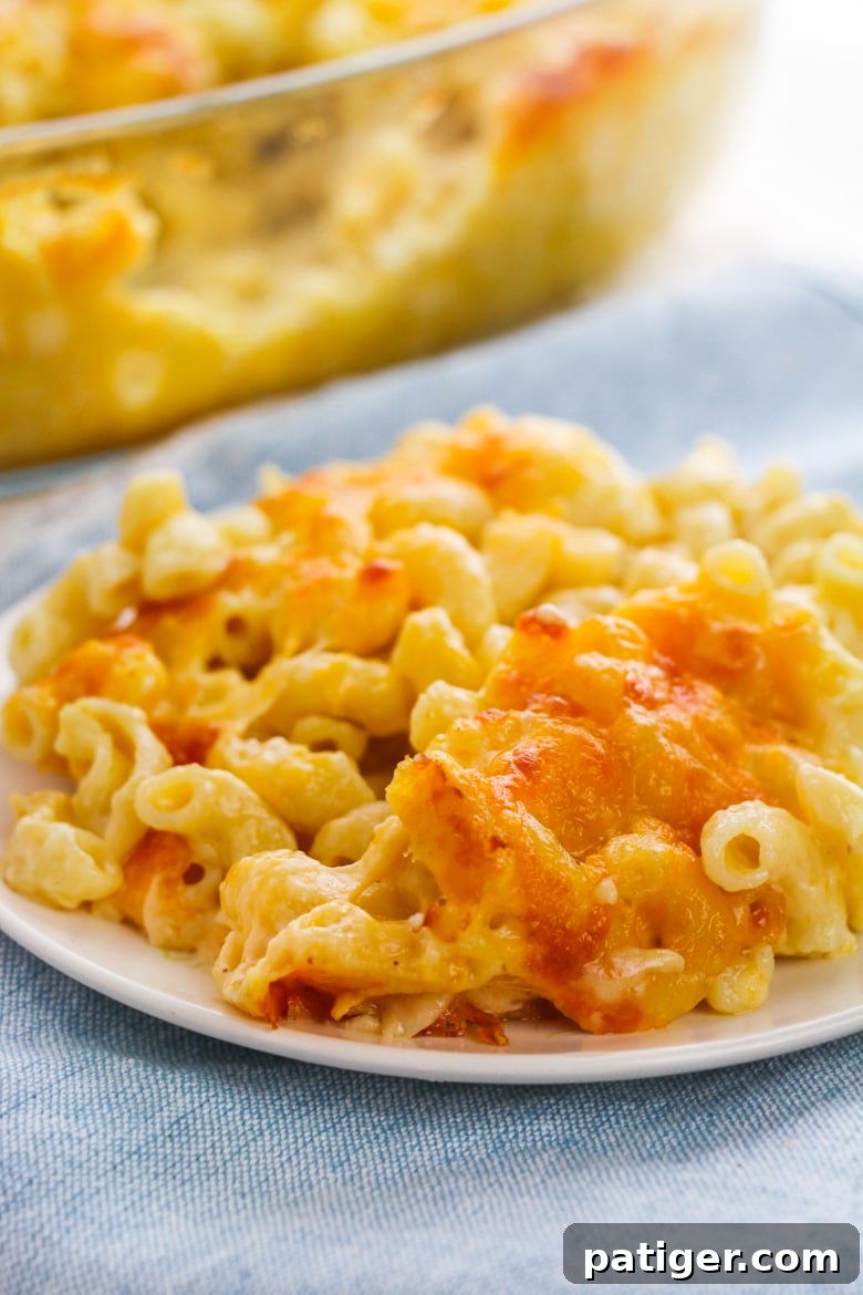 A baking dish of macaroni and cheese with a bubbly, golden top, fresh out of the oven