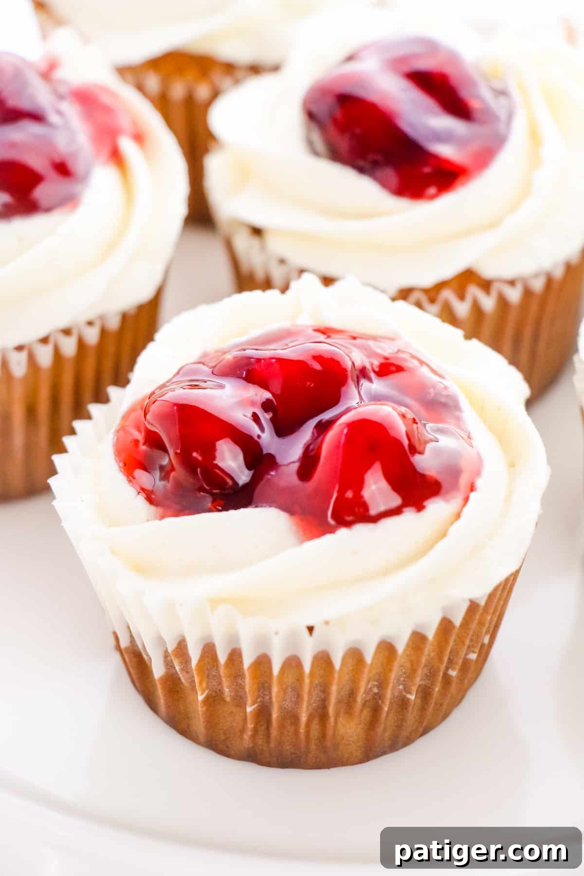 Indulgent Cherry Pie Cupcakes with creamy buttercream frosting and a visible cherry pie filling core