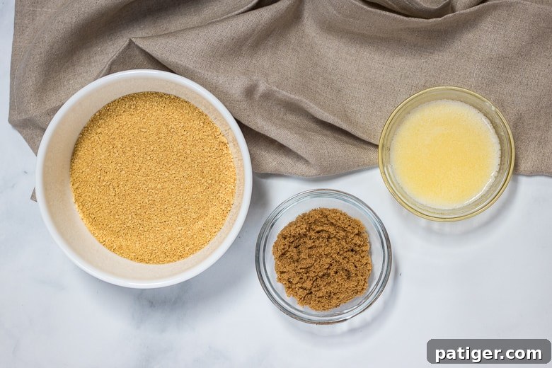 Key ingredients for the graham cracker crust: finely crushed graham cracker crumbs, rich brown sugar, and melted unsalted butter.