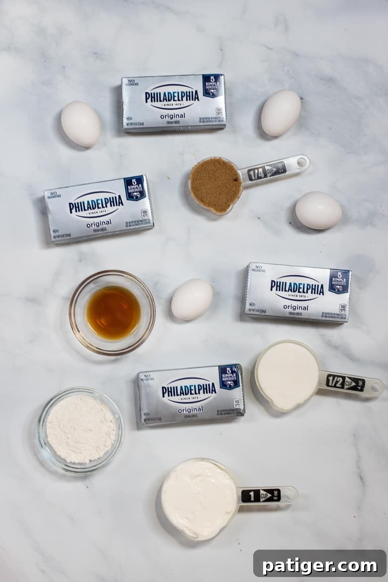 Main ingredients for the silky cheesecake filling: softened Philadelphia Cream Cheese, granulated sugar, brown sugar, eggs, sour cream, flour, and vanilla extract.