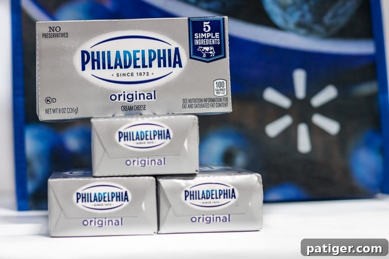 Multiple packages of Philadelphia Cream Cheese displayed, highlighting its availability and essential role in baking.